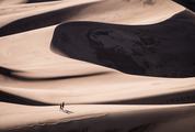 Couple Walking Through the Sand Dunes