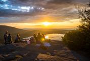 Sunset in the Mountains - Group of People Sitting with Beautiful View of Lake