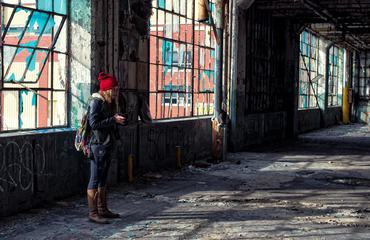 A Woman Taking a Photo in an Old Destroyed Factory