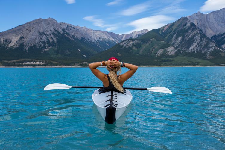 Woman in the Kayak Enjoying the View of Mountains