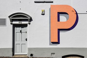 Grey Wall with Orange Letter and the Grey Door