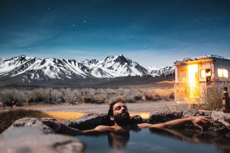Bearded Man Relaxing and Drinking Beer in the Water