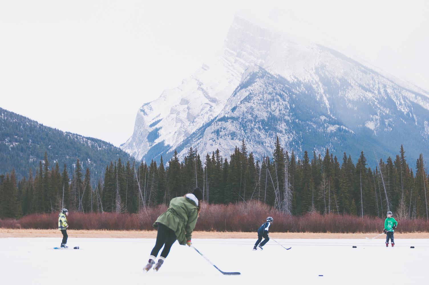 Kids Playing Outdoor Hockey at the Foot of the Mountain