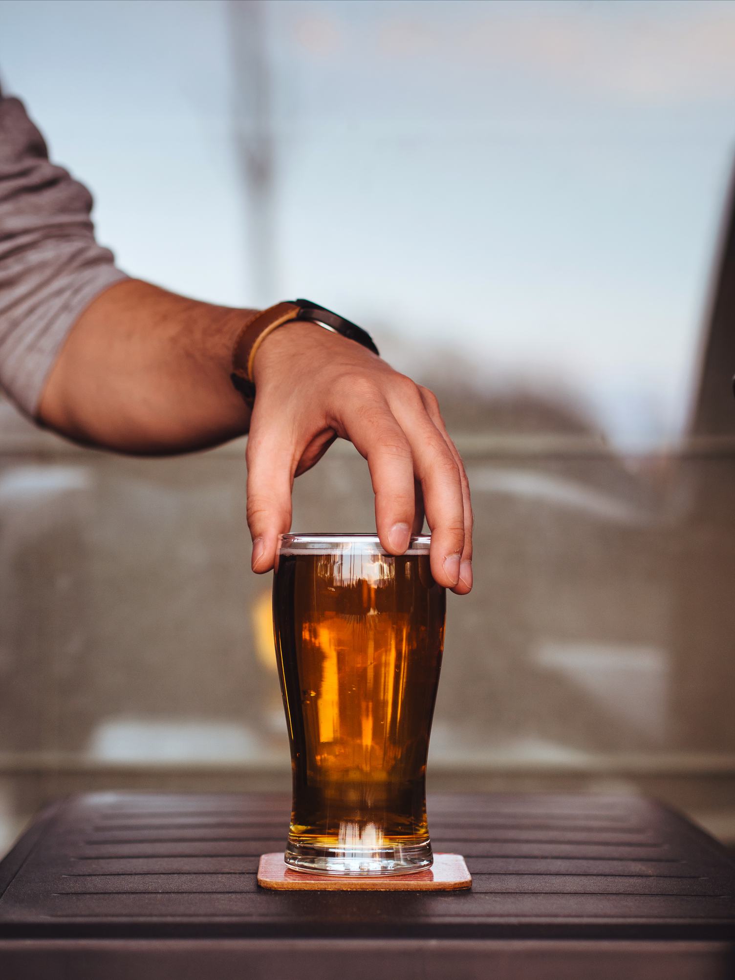 Man Holding Glass of Beer