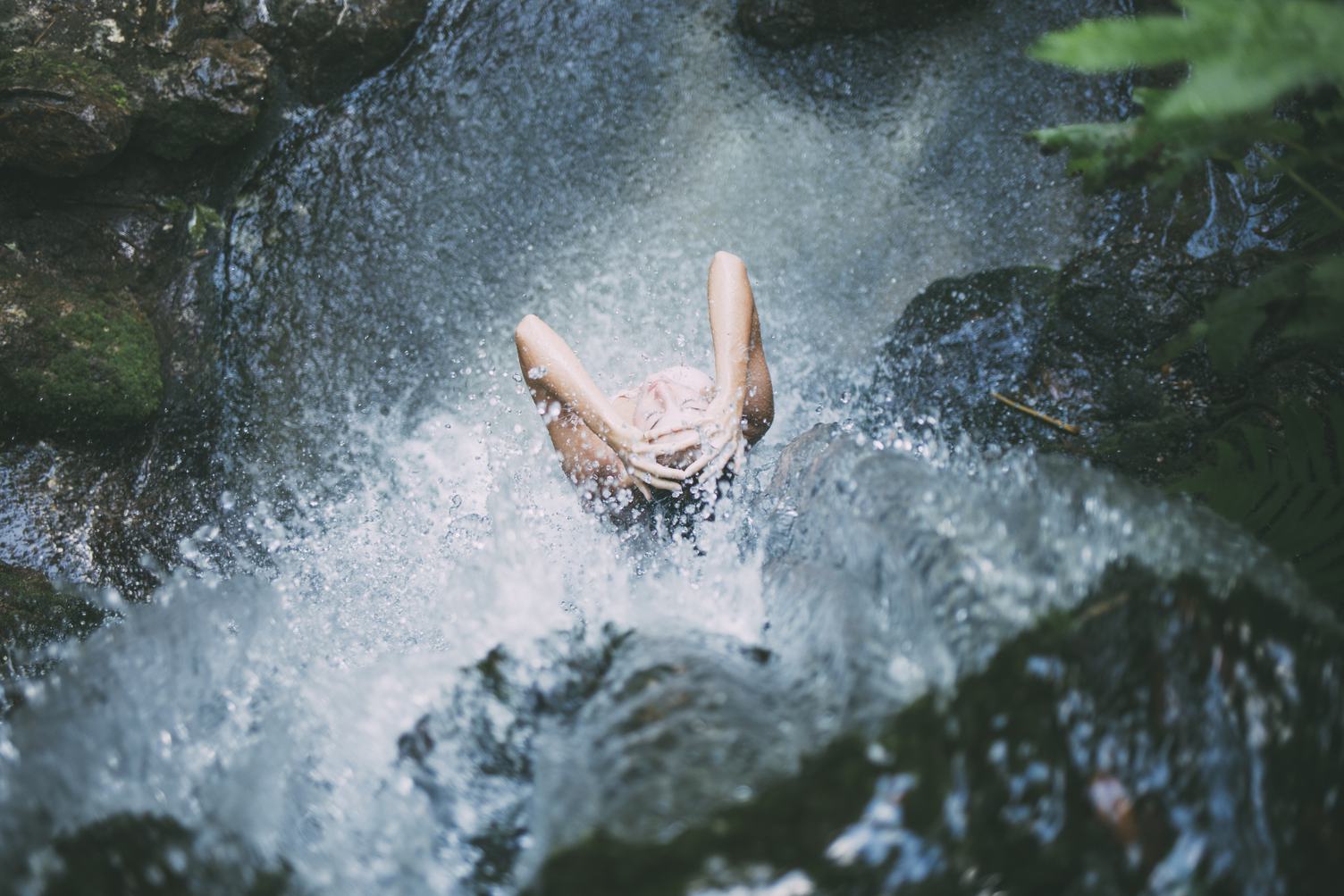 Woman Taking a Bath in the Waterfall