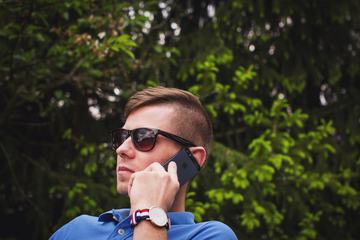 Young Man Wearing Sunglasses Talking on the Phone
