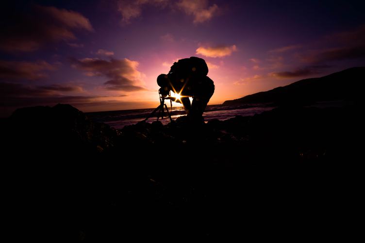 Photographer and His Camera on Tripod at Sunset.