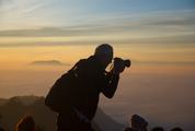 Elder Man Takes a Photo Misty Valley from Mountain Peak