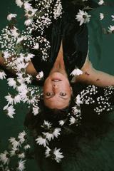 Brunette Floating with White Flowers