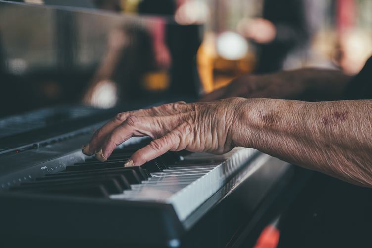Hands of an Old Man Playing the Piano