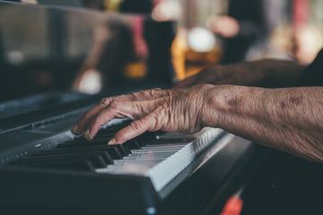 Hands of an Old Man Playing the Piano