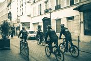 Police Patrol on Bicycles in a Small City Street