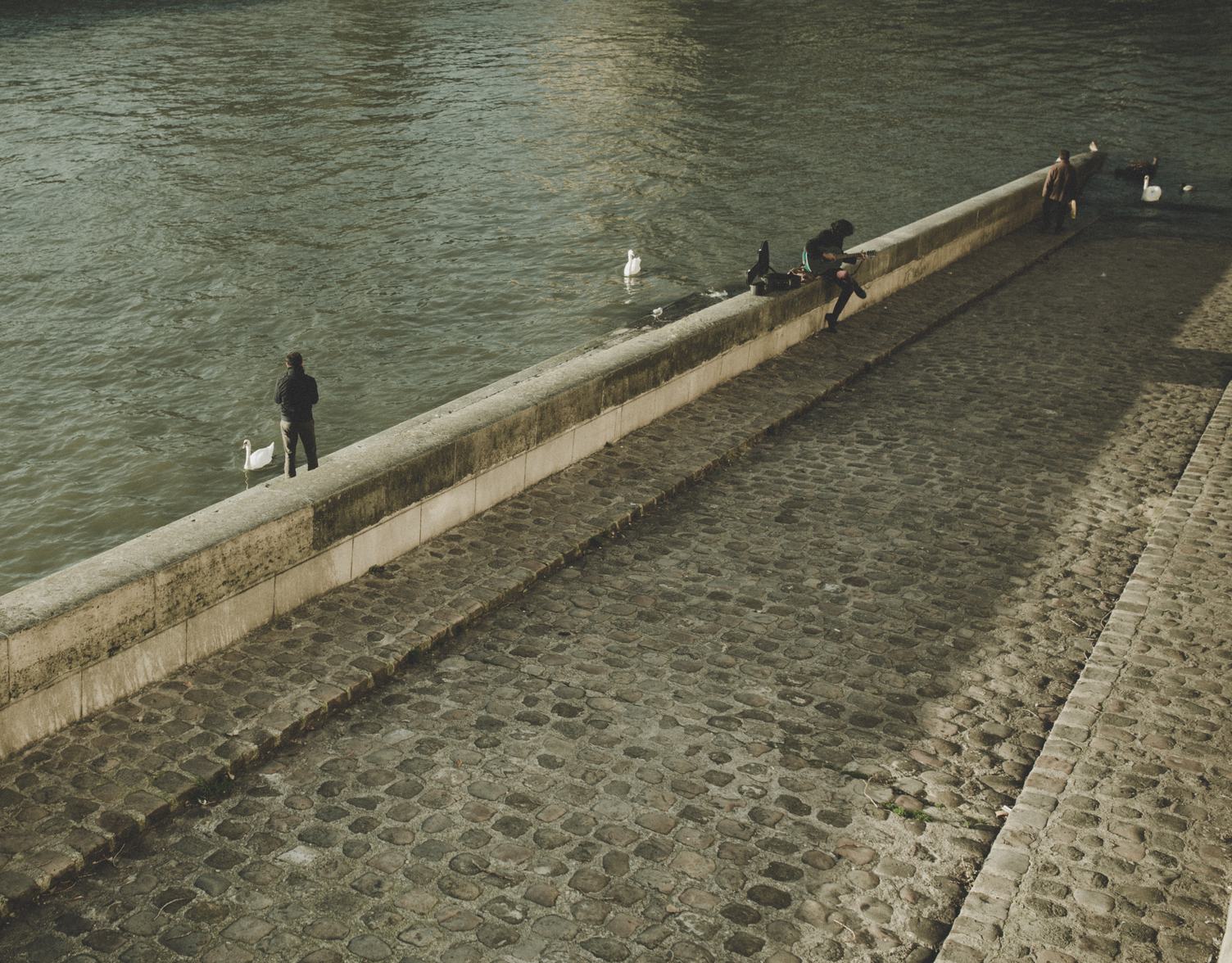 Pedestrians on the Paved Embankment