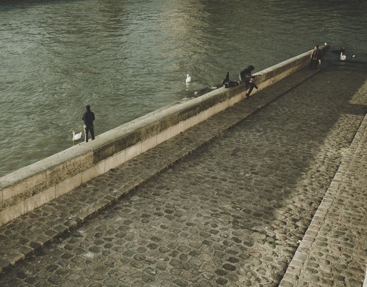 Pedestrians on the Paved Embankment