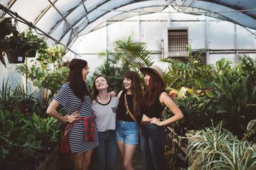 Group of Young Girls Laughing in a Greenhouse