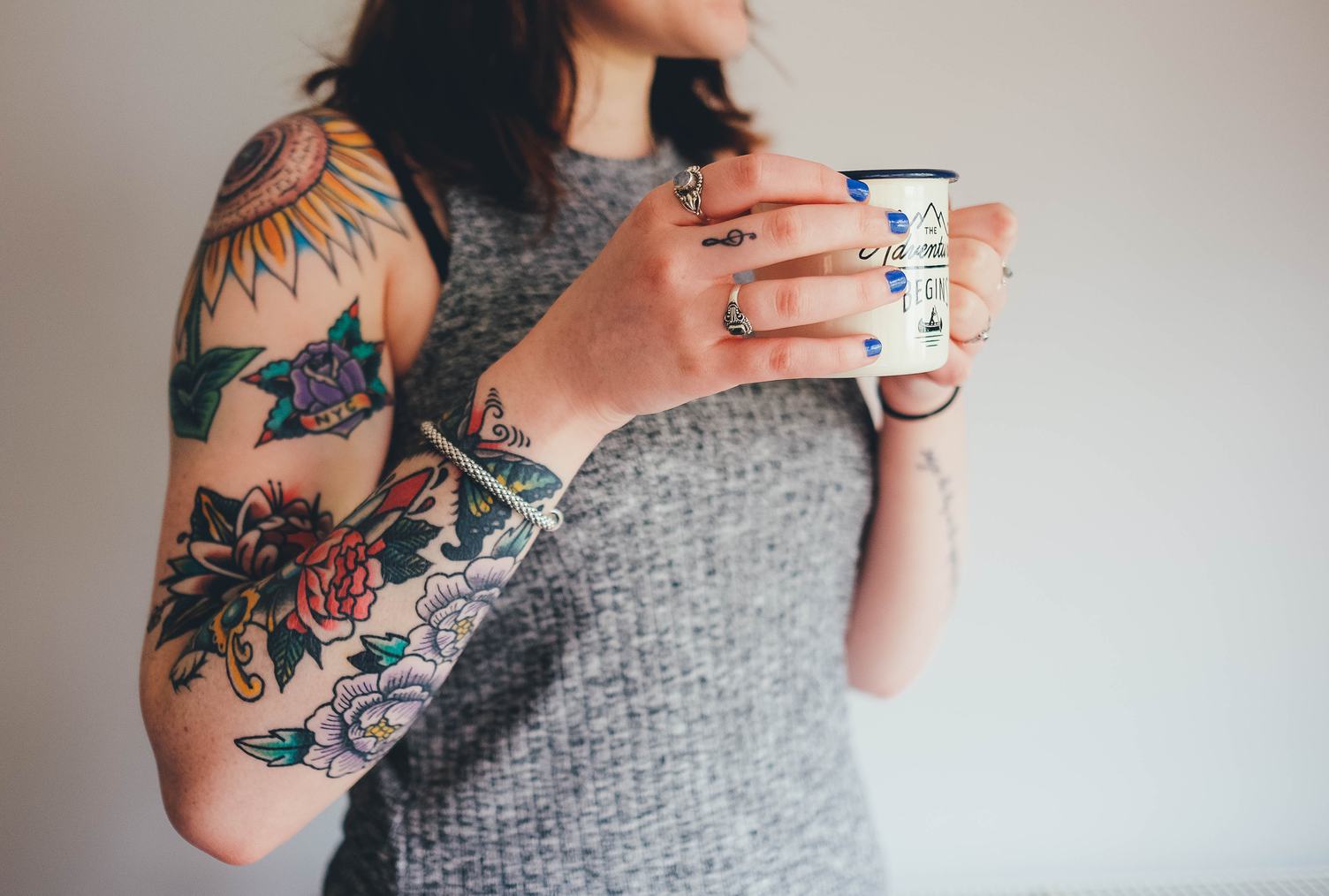 Tattooed Woman Holding a Mug