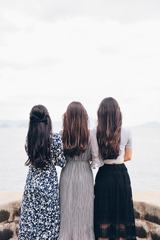 Back View of Three Brunettes in Long Dresses