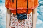 Vintage-Style Dressed Girl Photographer with her Camera