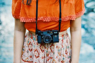 Vintage-Style Dressed Girl Photographer with her Camera