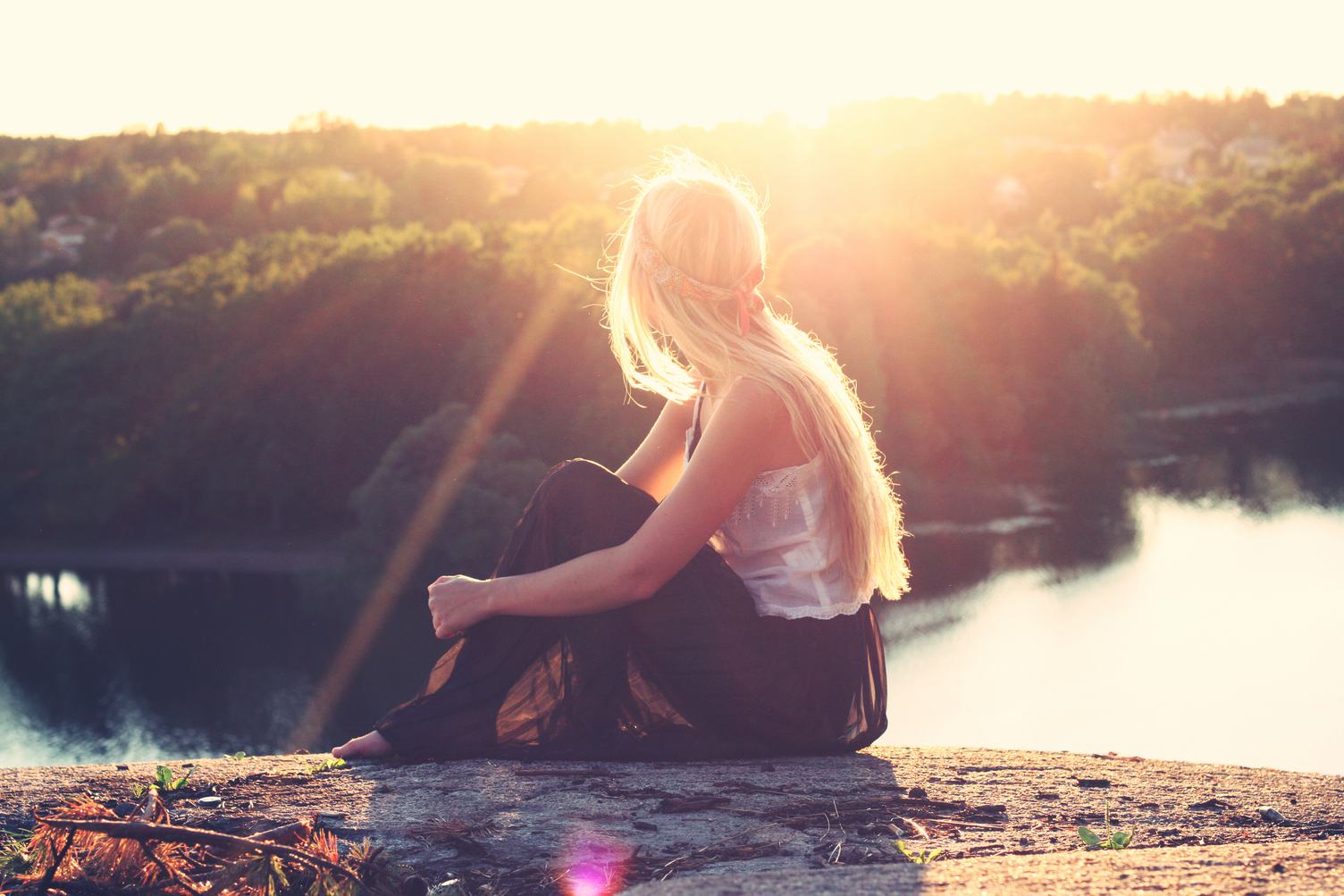 Blond Girls Sitting on a Cliff in the Sun