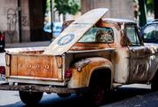 Rusty Pickup with a Surf Board