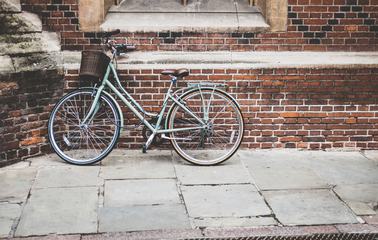 Vintage Bike with a Basket Against a Red Bricks Wall