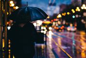 Person under Umbrella in the Evening City