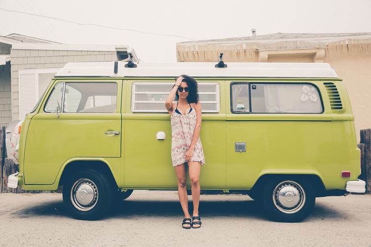 Woman Standing in front of Volkswagen Minibus