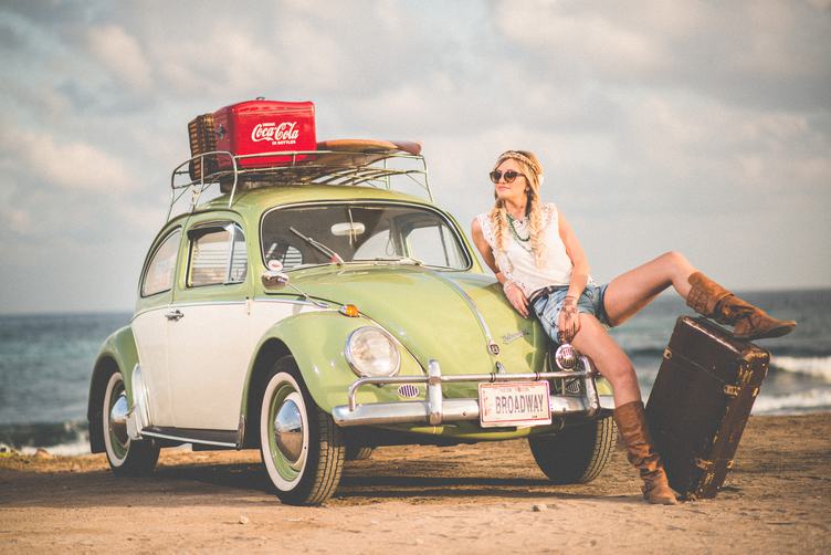 Blonde Girl with Braids and Green Retro Volkswagen Beetle