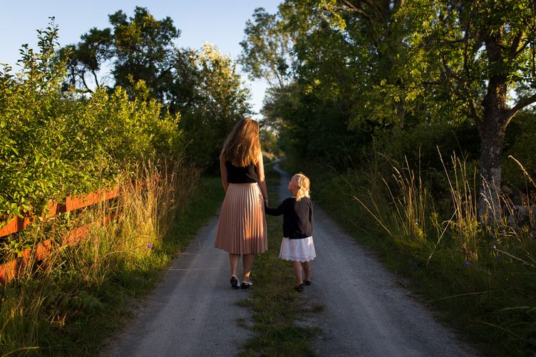 Mother and Daughter Walking Holding Hands