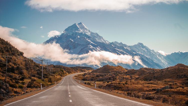 Road Leading Towards a Snow Capped Mountain in New Zealand