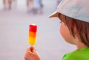 Boy with Ice Lolly in a Baseball Cap