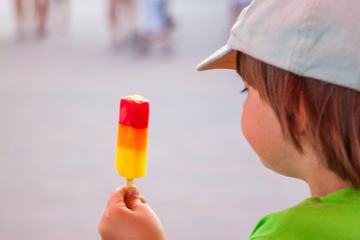 Boy with Ice Lolly in a Baseball Cap