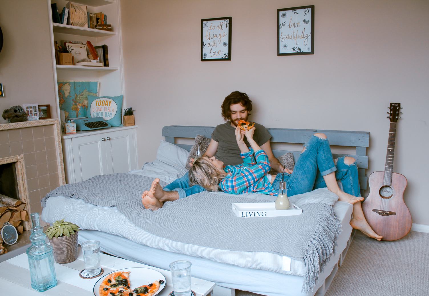 Couple Feeding each other in Bed with Pizza