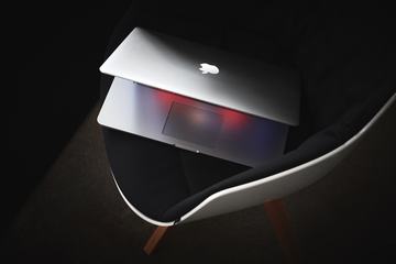 MacBook on Black Modern Chair