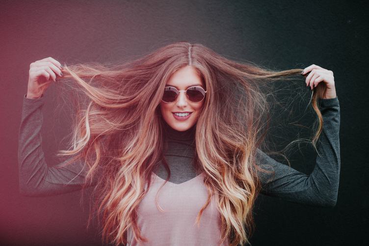 Smiling Woman in Sunglasses with Long Hair