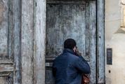 Man Wearing Navy Blue Jacket Opening the Door