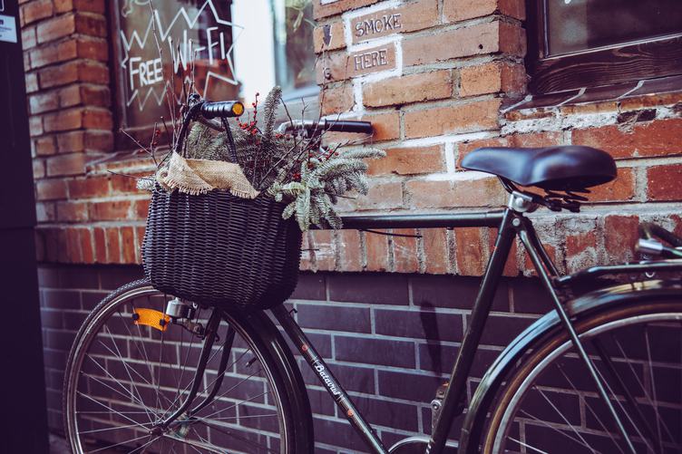 City Bicycle with Basket in Front of the Old Brick Wall