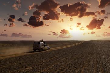 Offroad Trail Car Speeding Through the Desert at Sunset