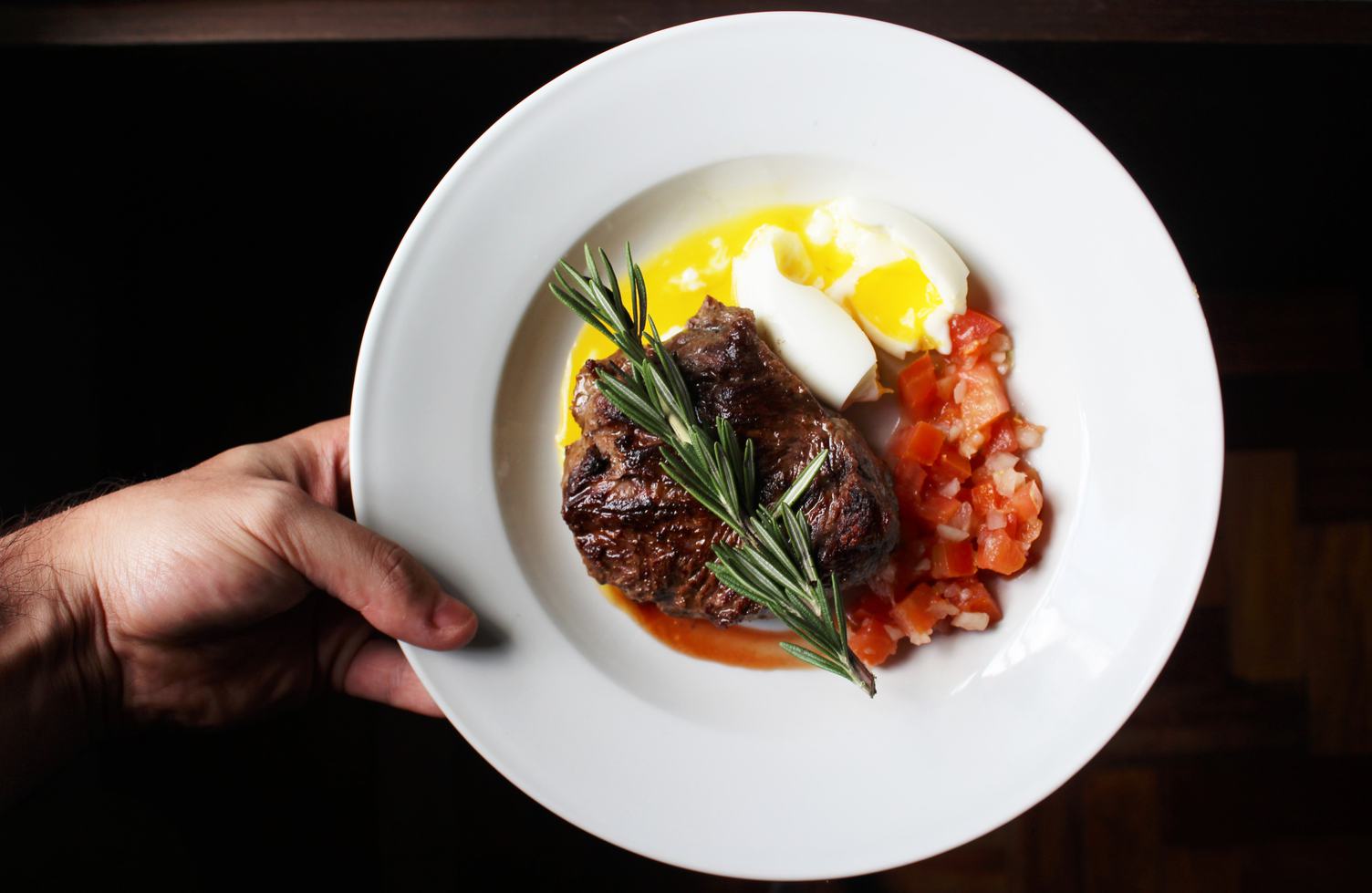 Steak with Tomatoes and Soft-Boiled Egg on the White Plate