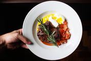 Steak with Tomatoes and Soft-Boiled Egg on the White Plate