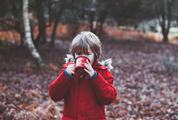 Little Cute Boy Drinks from a Metal Cup in the Autumn Park