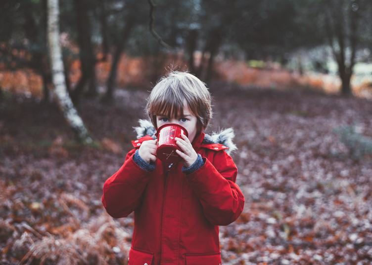 Little Cute Boy Drinks from a Metal Cup in the Autumn Park