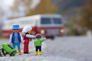 Miniature Family Traveling by Bus with Backpack, Macro Photography.