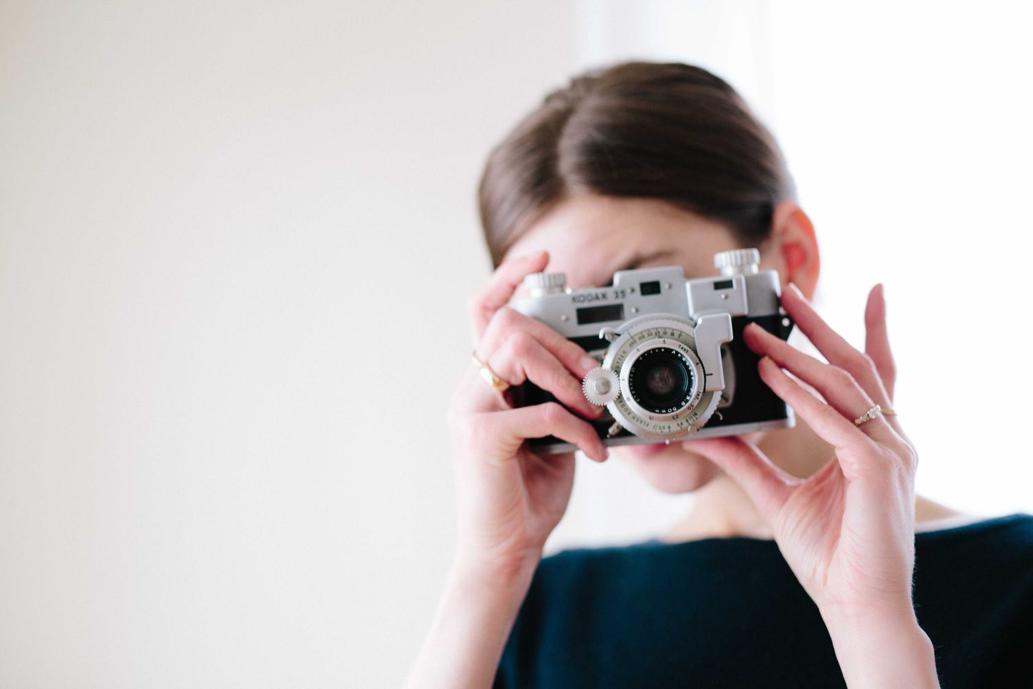 Woman with Vintage Camera in the Hands