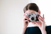 Woman with Vintage Camera in the Hands