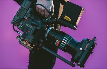 Video Camera Operator Carrying His Professional Equipment