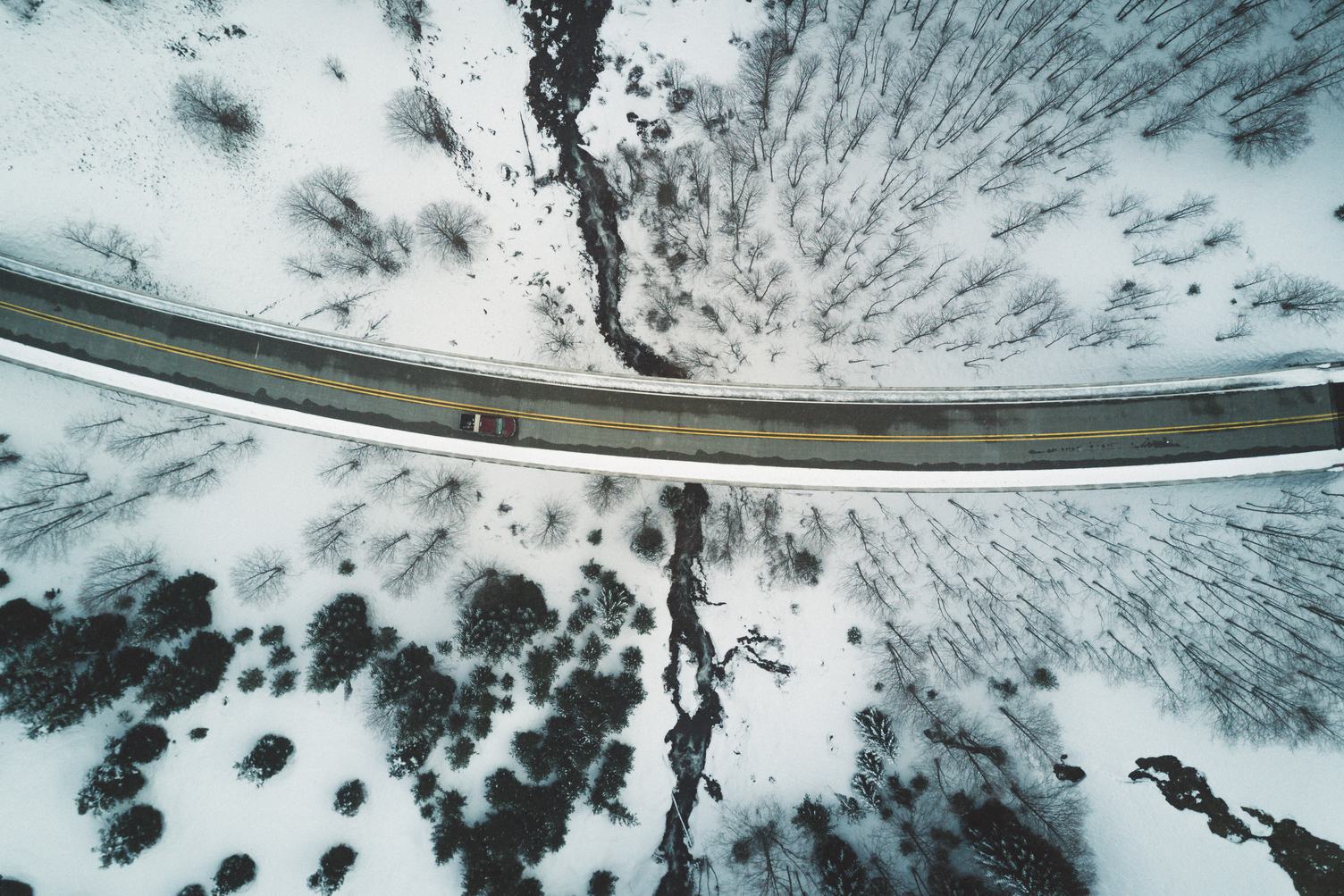 Aerial Shot of Snow Covered Road Curve