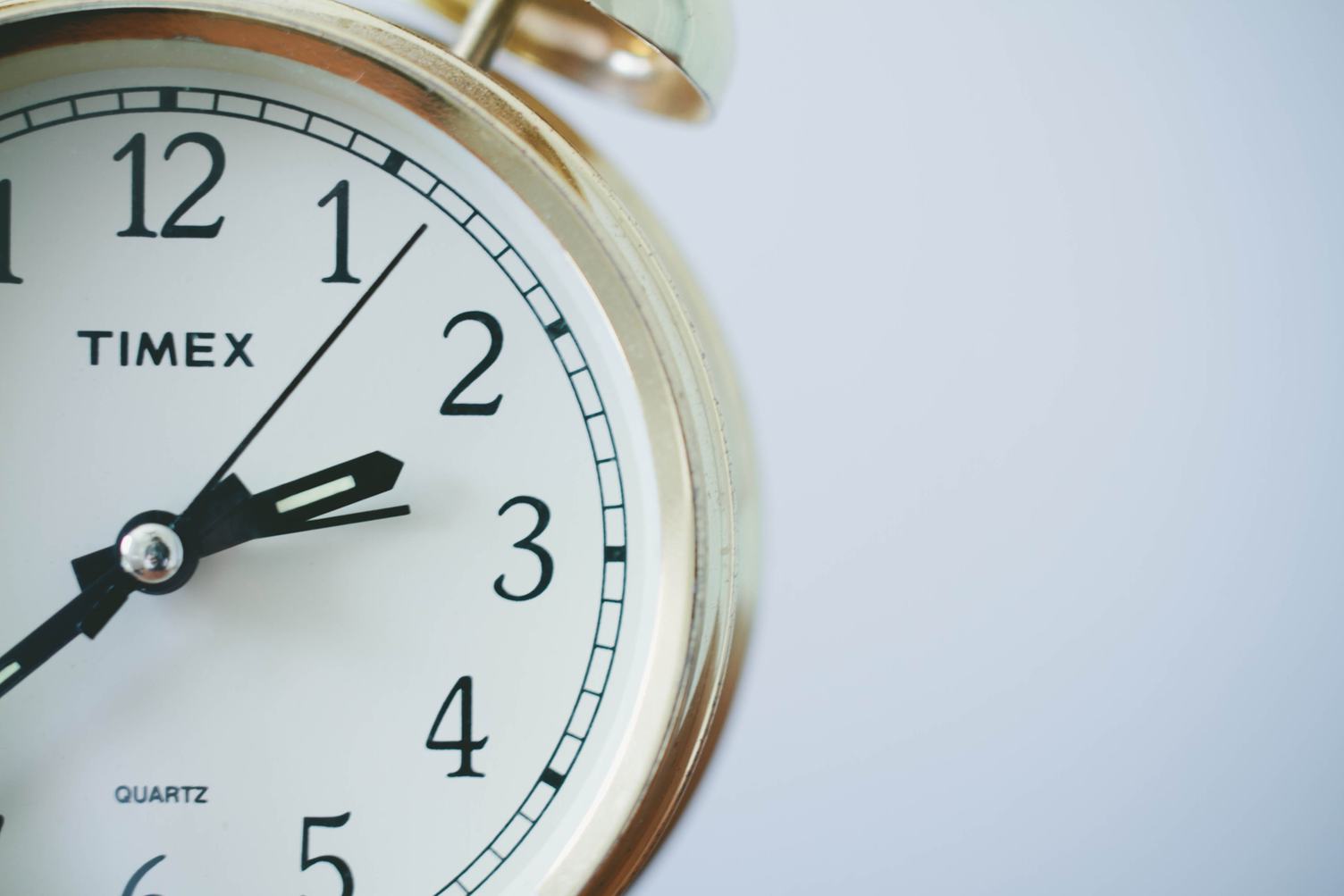 Old Alarm Clock on White Background Closeup