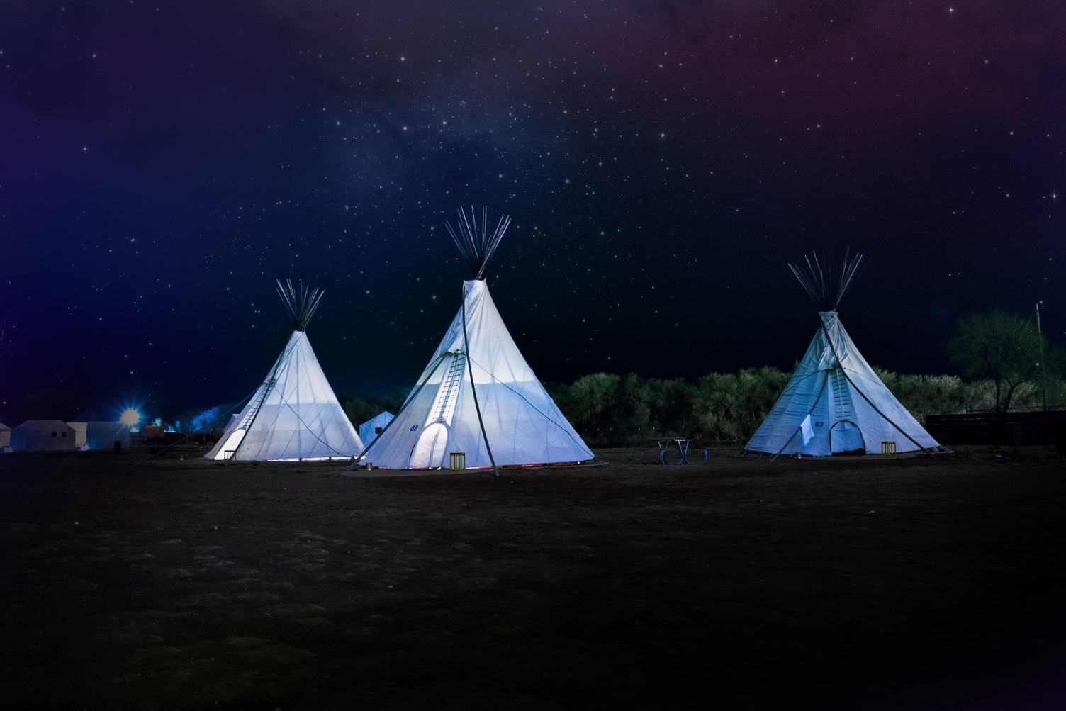 Three Tipi Tents at Night